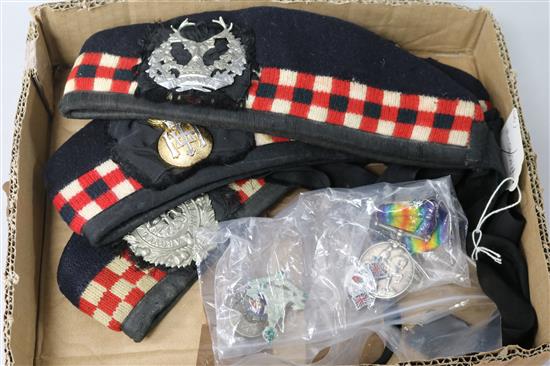 Three Glengarry caps, WWI medal and badges including Red Hand of Ulster.
